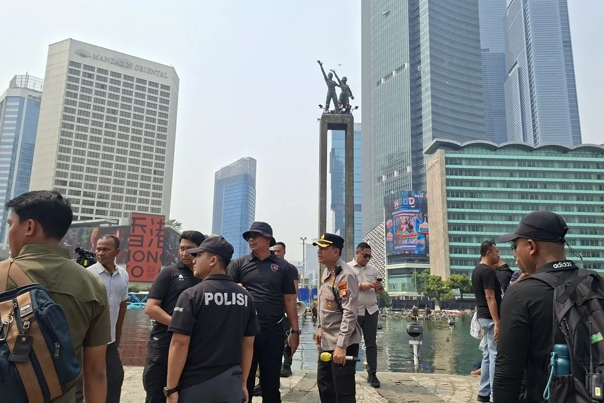 Polisi menurunkan spanduk yang di pasang oleh Aktivis Greenpeace di Bundaran HI 20/10/2026